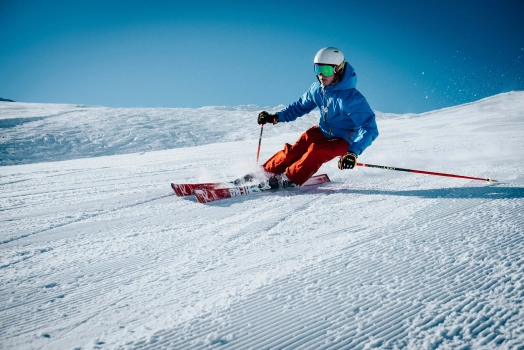 A skier glides down a snow-covered slope