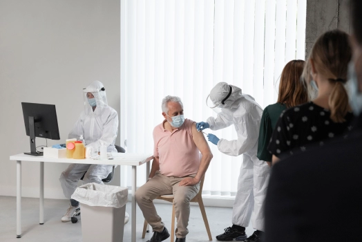 Doctor vaccinating a patient at a center