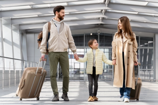 Happy family with their luggage at airport