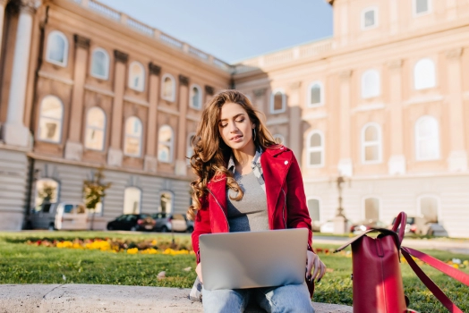 Female student using her laptop outdoors