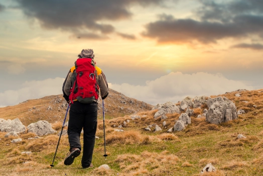 Hiker with backpack on top of a mountain