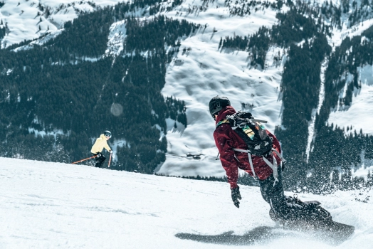 Skier skiing snowy mountain at daylight